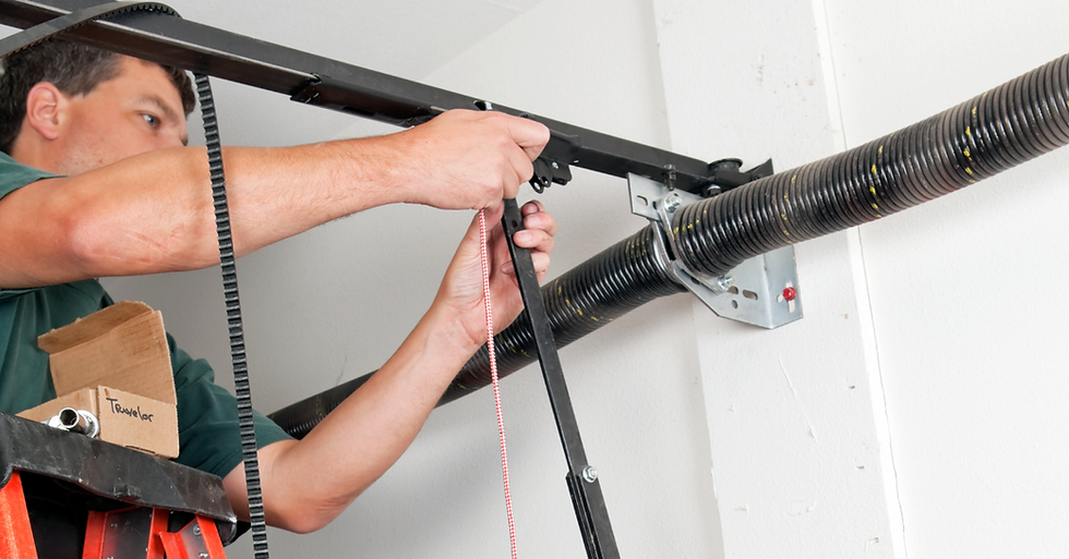 A person on a ladder adjusts a garage door spring with a red and white cord. A cardboard box labeled "Towelar" is nearby.