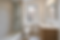 Small NYC apartment bathroom with walk-in shower, wood vanity, and city view through windo