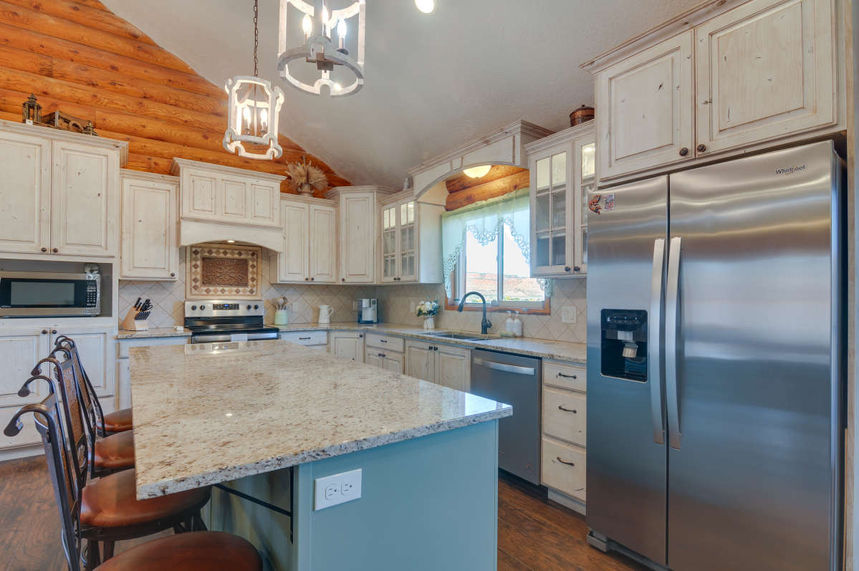 Log home in Southern Utah with antique-white kitchen cabinets