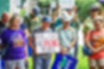 During a press conference at Piedmont Park organized by 'Fired But Fighting' on Sunday, Aug. 10, 2025, people pay their respects to DeKalb County Police Officer David Rose, who was fatally shot by the gunman who opened fire at CDC headquarters in Atlanta on Friday