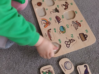 Close-up of a child playing with an educational wooden toy
