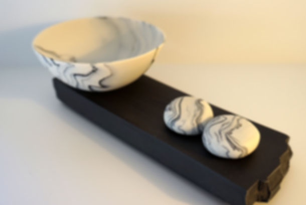 Inlaid Rocking Bowl and 2 Pebbles on Black Porcelain Plinth