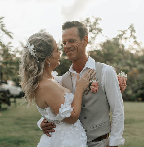Newlywed couple posing for romantic post-ceremony wedding portraits in Barbados, celebrating their marriage with beachside photography.