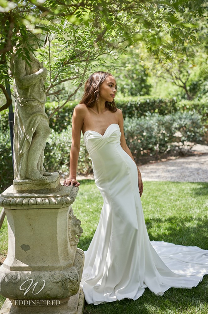 A Monique Lhuillier Bliss Spring 2021 strapless satin mermaid wedding dress with a train
