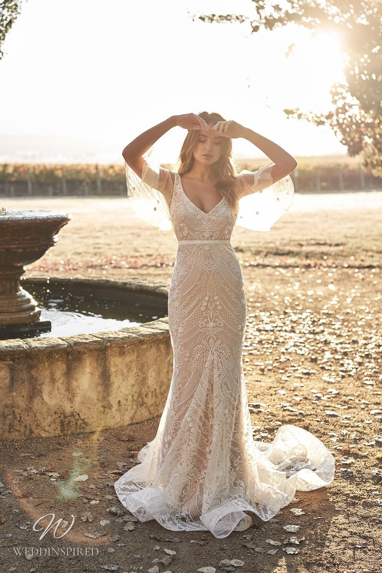 An Anna Campbell 2020 blush fitted lace, v neck wedding dress with draped tulle sleeves