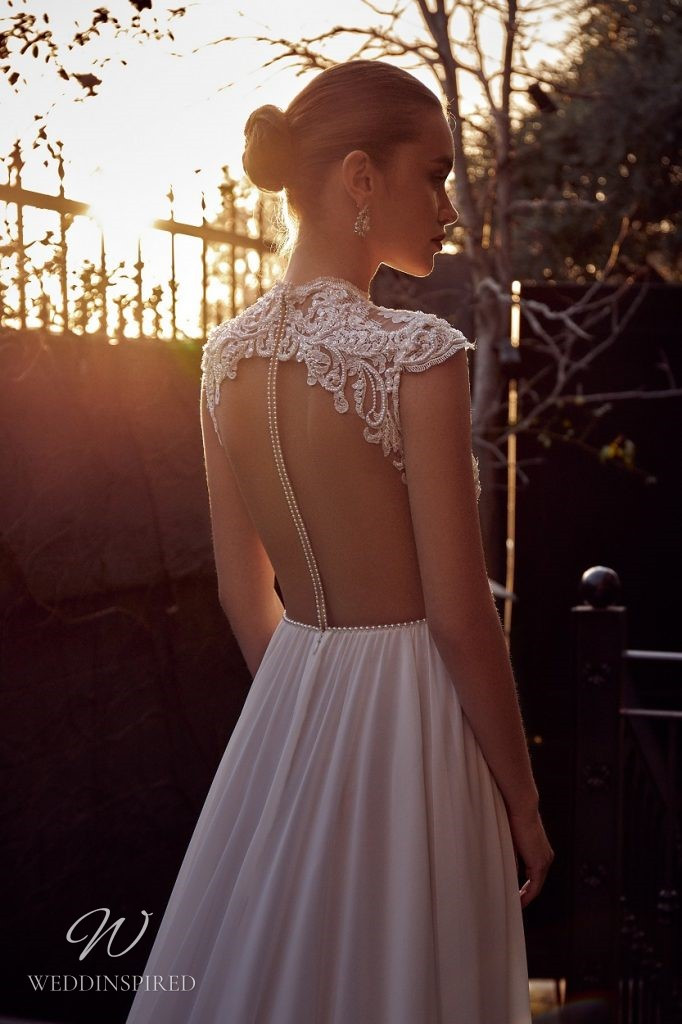 A Julie Vino 2021 ivory lace and chiffon A-line wedding dress with cap sleeves and an open back