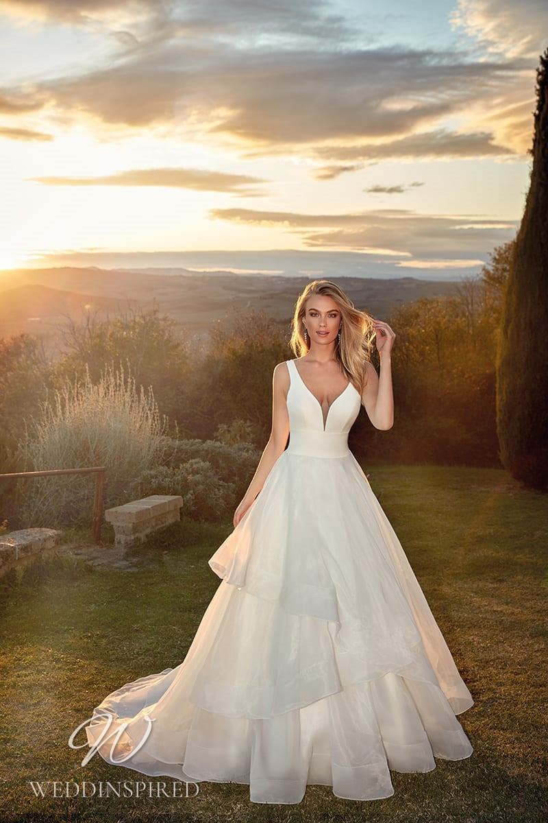 An Eddy K 2021 satin and organza A-line wedding dress with a ruffle skirt