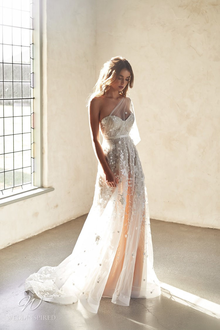 An Anna Campbell 2020 blush one shoulder A-line wedding dress with a tulle skirt and beading