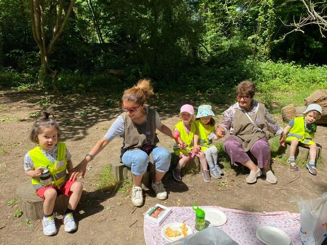 Smile and shine nursery staff with children.