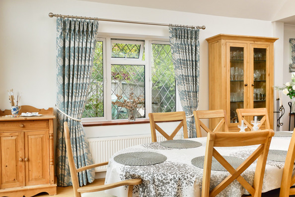 Full length dining room curtains with double pleats.