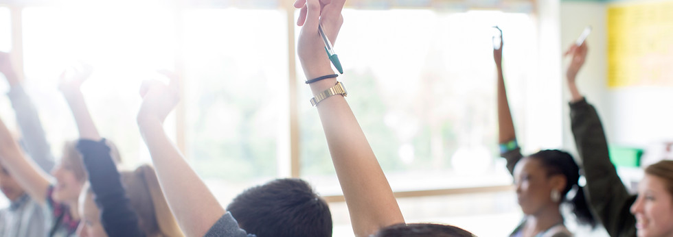 Teenage Students Raising Hands