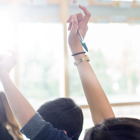 Teenage Students Raising Hands