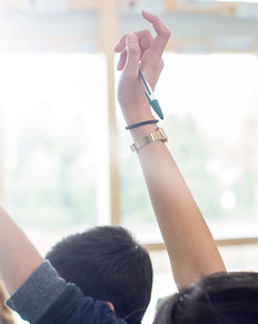 Teenage Students Raising Hands