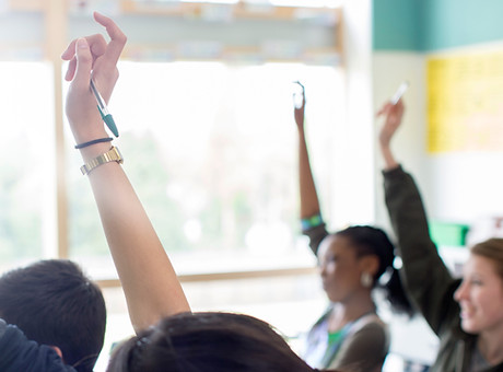 Teenage Students Raising Hands