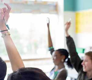 Teenage Students Raising Hands