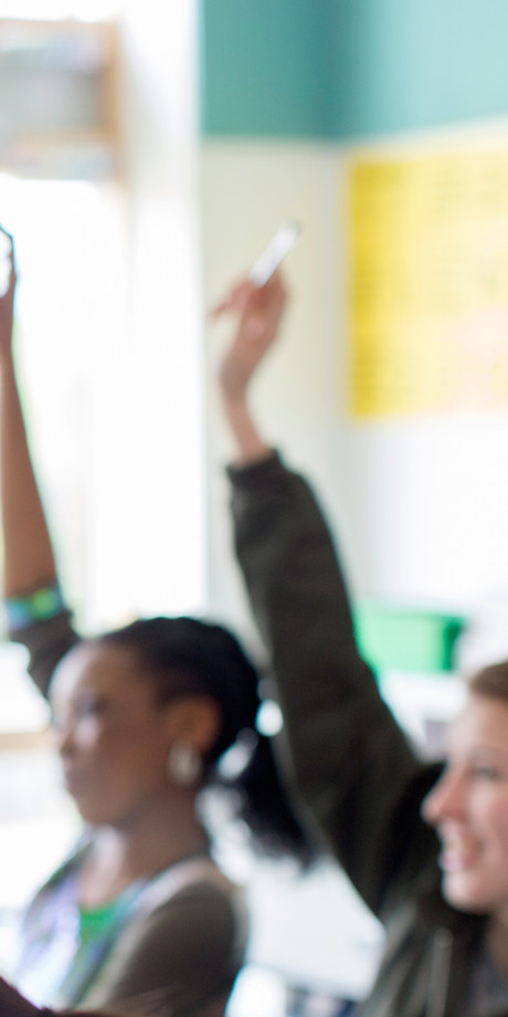 Teenage Students Raising Hands