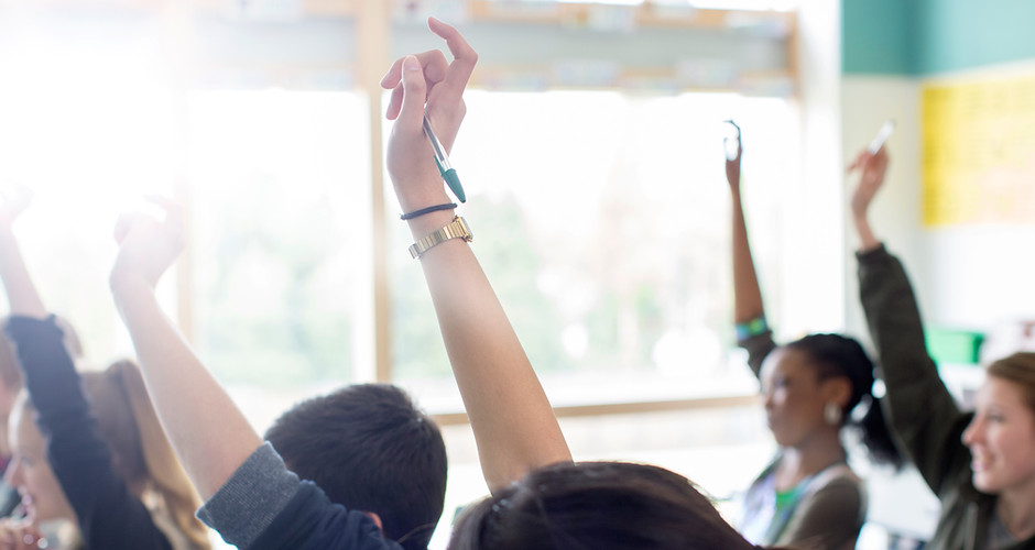 Teenage Students Raising Hands