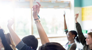Teenage Students Raising Hands