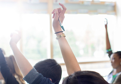 Teenage Students Raising Hands