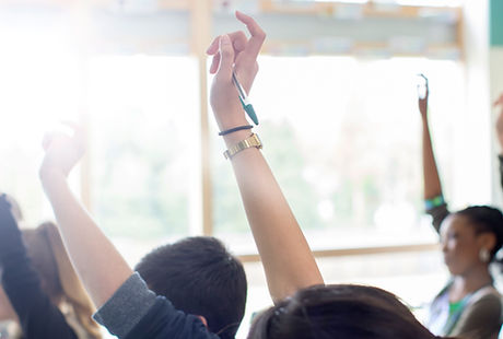 Teenage Students Raising Hands
