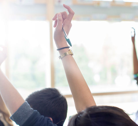 Teenage Students Raising Hands