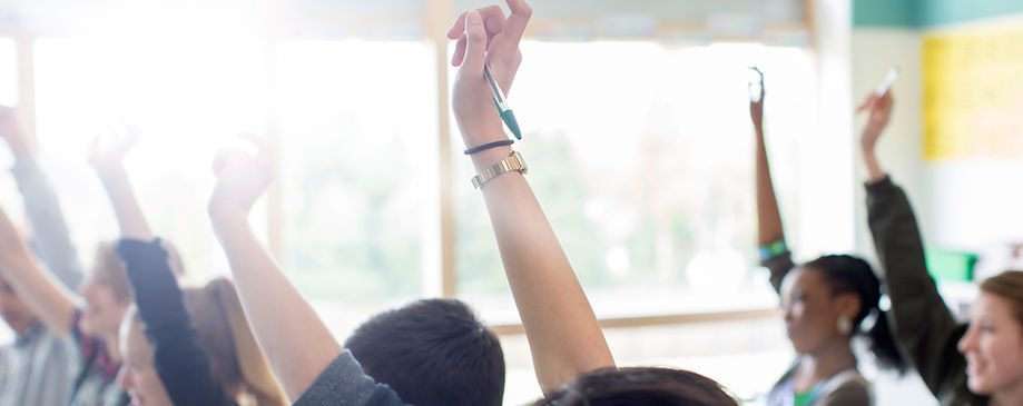 Teenage Students Raising Hands