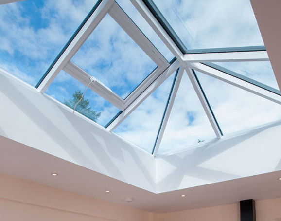 Ground view looking up at skies through glass roof