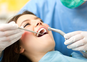 Dentist curing a female patient