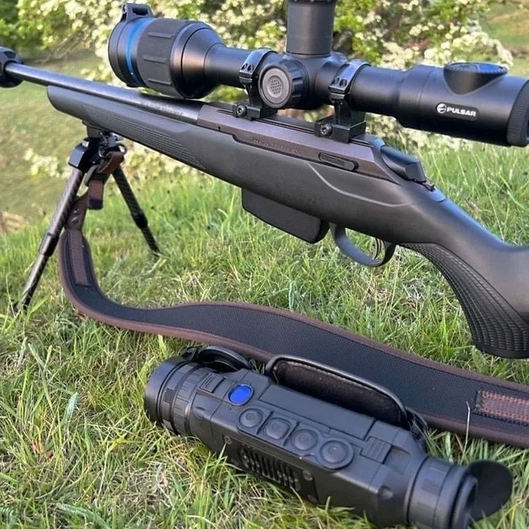 Night vision scope on a rifle outdoors for testing.