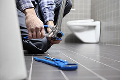 Hands plumber at work in a bathroom, plumbing repair service