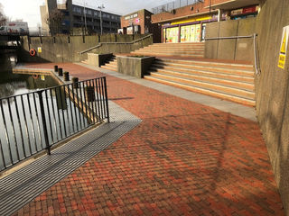 Red bricked area near a pond