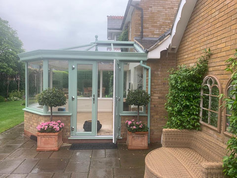 Outside view of light green conservatory 