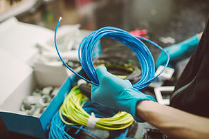 Man holding a roll of electric cable, Spain