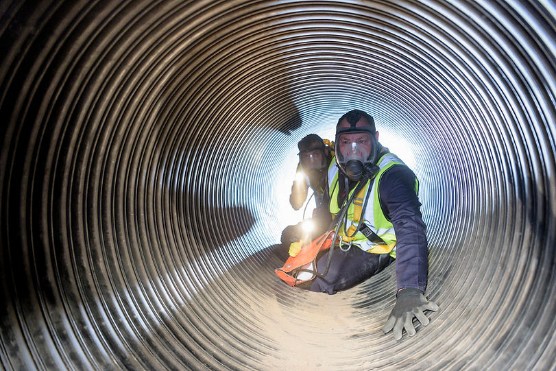 Apprentice builders training in confined space in training facility
