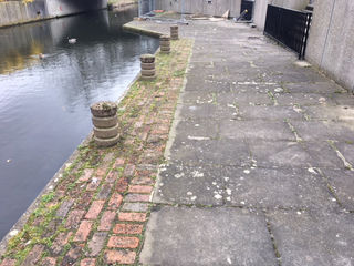 Old, worn out paving near a pond