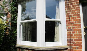 Vertical sliding window with white frames at domestic property