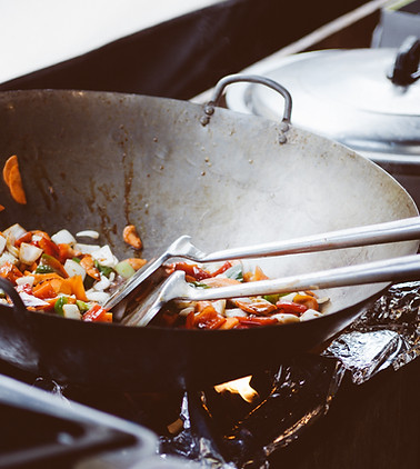 Vegetable stir-fry cooking in a wok