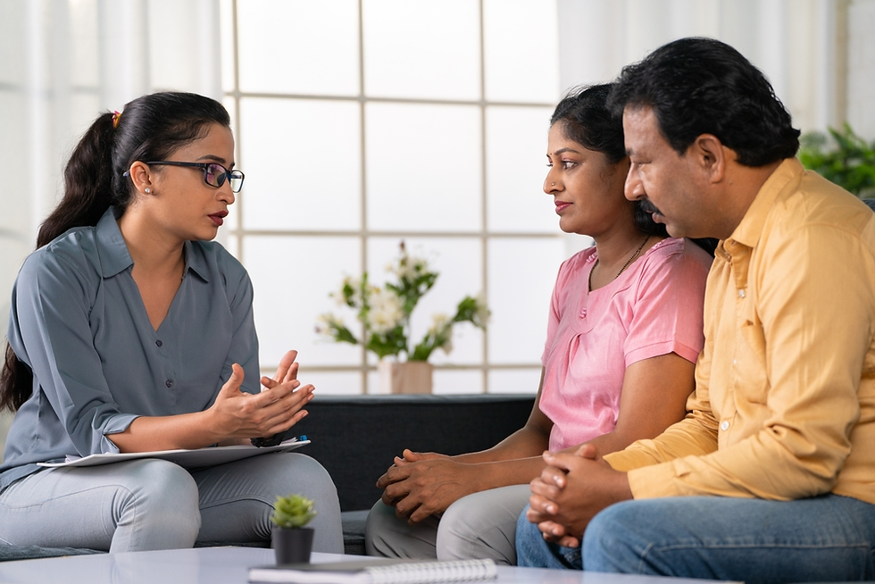 Indian couple in a counseling session with a female therapist, discussing relationship issues and emotional wellness.