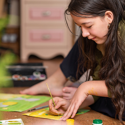 teenage-girl-painting-a-picture-on-the-floor-2026-03-18-13-50-29-utc.jpg