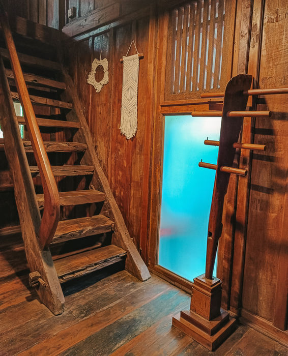 Cozy wooden living space in Marigold cottage with tropical accents in Bali.