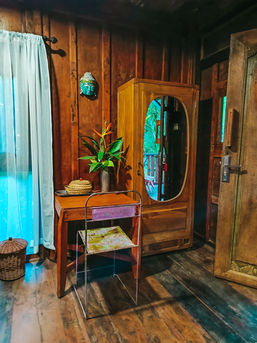 Rustic wooden living room in Marigold cottage with Balinese decor in Pemuteran.