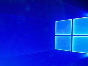Gambar: Logo Windows 10 berwarna biru menyala dengan latar belakang gradasi biru.