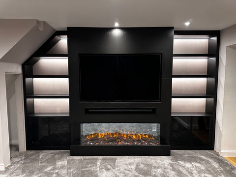 Elegant bespoke media wall with a built-in fireplace, meticulously crafted and custom-made to perfection. Fitted seamlessly into the room, this stunning feature combines functionality with style. The contemporary design is enhanced by integrated LED lighting, creating a warm and inviting ambiance for your living space