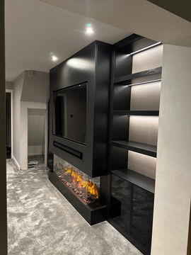 Elegant bespoke media wall with a built-in fireplace, meticulously crafted and custom-made to perfection. Fitted seamlessly into the room, this stunning feature combines functionality with style. The contemporary design is enhanced by integrated LED lighting, creating a warm and inviting ambiance for your living space