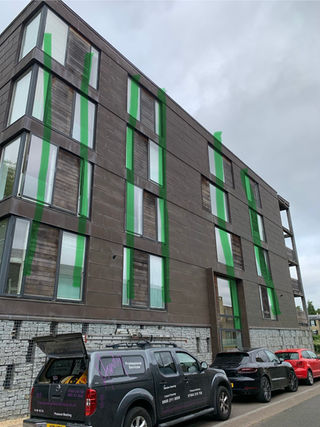 Commercial window cleaning on a multi-story brick building.