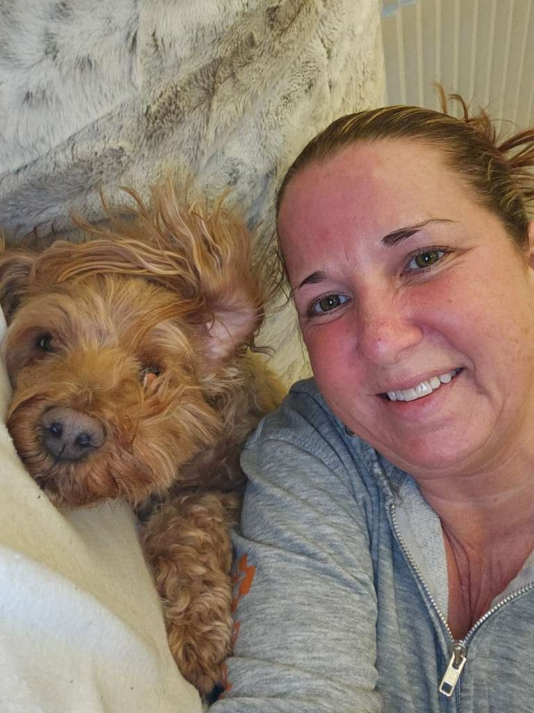 Nichole getting cuddles with her furry client. 