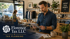 Man reviews tablet in boutique shop; Florence Tax LLC tax planning text, with SUPPORT LOCAL BUSINESS sign.