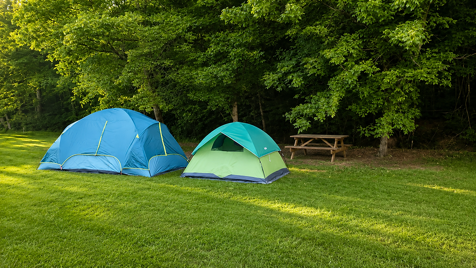 Two tents at quiet creekside campground site