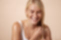 Studio shot of a happy caucasian woman adjusting her hair with closed eyes.jpeg