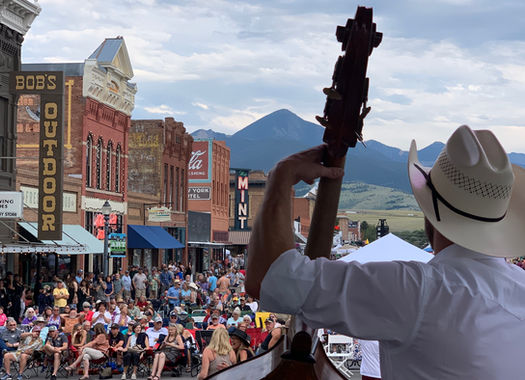 The back of Matthew Mefford on stage in Montana with a view of the audience in the background
